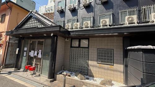 a building with a balcony on top of it at 心斎橋難波南Ambers hotel 3322 in Osaka