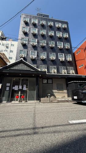 a building with balconies on the side of a street at 心斎橋難波南Ambers hotel 3322 in Osaka
