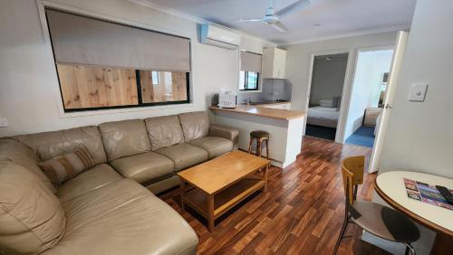 a living room with a couch and a table at T's Resort & Motel in Port Macquarie