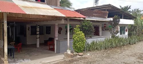 a small white house with a red roof at Blackys 