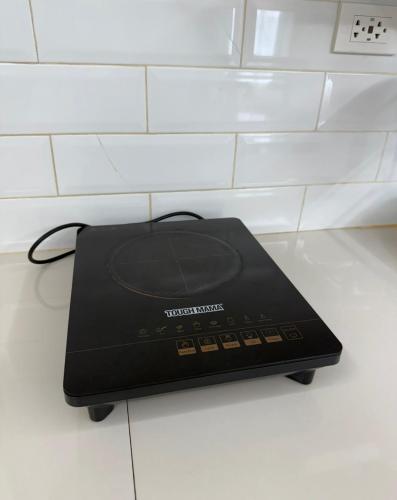 a black router sitting on top of a counter at DaLei 2-330 Sleeps 8pax at Marina Spatial Condominium in Dumaguete City in Dumaguete