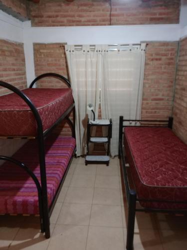 a room with two bunk beds and a window at Depto Los Nidos 4 o 5 personas in Villa Cura Brochero