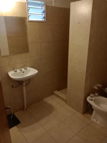 a bathroom with a sink and a shower and a toilet at Depto Los Nidos 4 o 5 personas in Villa Cura Brochero