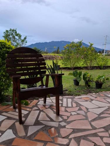 a wooden bench sitting on a stone patio at Legado Residence in Alto Boquete