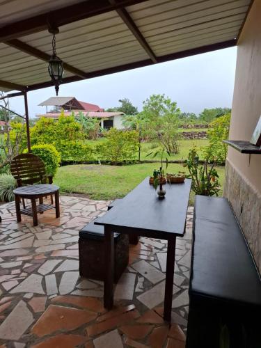 a patio with a table and benches on a stone patio at Legado Residence in Alto Boquete