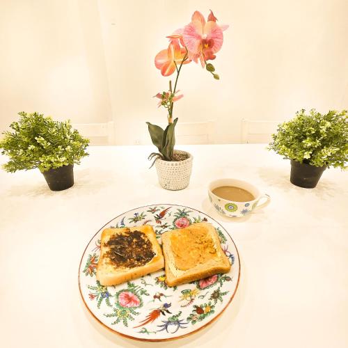 a plate of food with toast and a cup of coffee at The Frederick Guest House in Sydney
