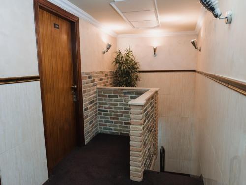 a hallway with a brick wall and a plant at Il Castello di Perano in Perano
