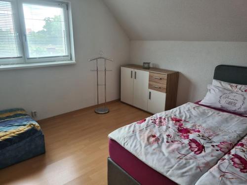a bedroom with a bed and a dresser in it at Fuhrmann Comfortable holiday residence in Neustrelitz