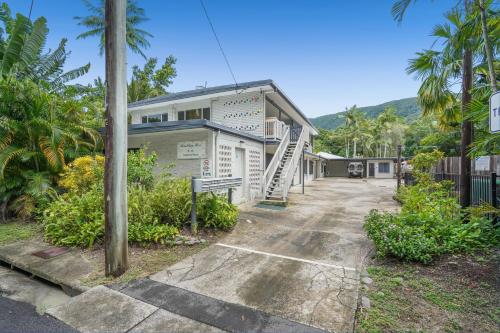 a white house with a staircase in front of it at Belle Escapes Relax Rose in Palm Cove