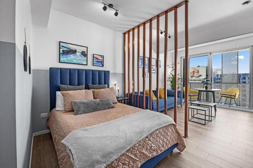 a bedroom with a king sized bed and a balcony at Airport and Volcano Views from 11th Floor Apartment in Guatemala