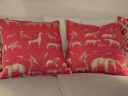 two red pillows sitting on top of a couch at Schroeder's House Kampen House 2 in Kampen
