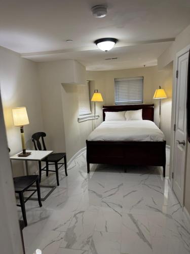 a bedroom with a bed and a desk and a table with chairs at Lovely Remodeled 2bdrm Basement Home in Washington