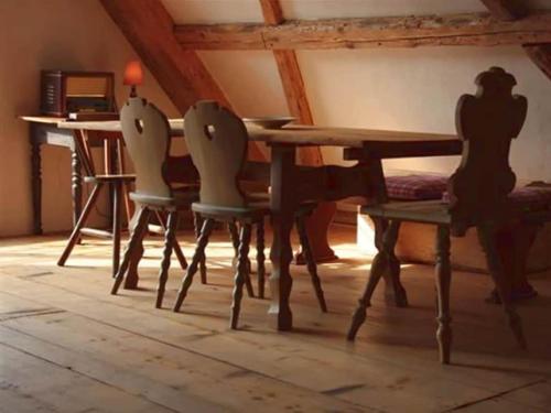 a dining room with a wooden table and two chairs at Holiday home in Wutach with swimming pool in Lembach