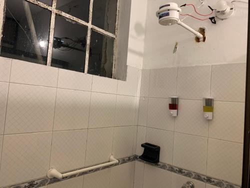 a bathroom with a broken window and a sink at Casa Samor La Candelaria in Bogotá