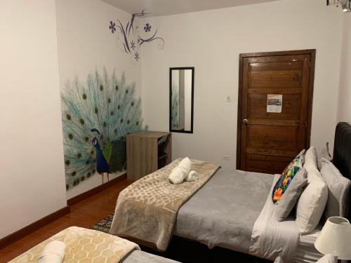 a bedroom with two beds and a mirror and a door at Casa Samor La Candelaria in Bogotá