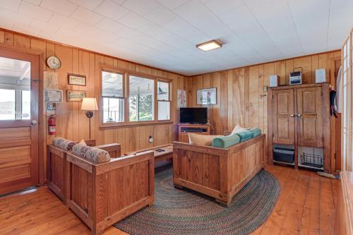 a living room with wooden walls and wooden floors at Dock and Rowboat Beechnut Bungalow on Keuka Lake in Branchport