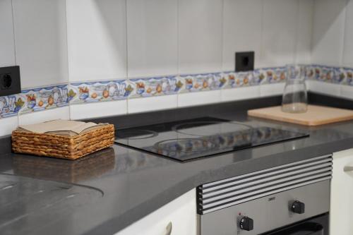 a kitchen counter with a stove and a basket on it at Brisas al mar in Candelaria