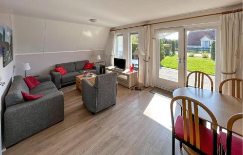 a living room with a couch and a table at Bungalow 195 in Den Oever
