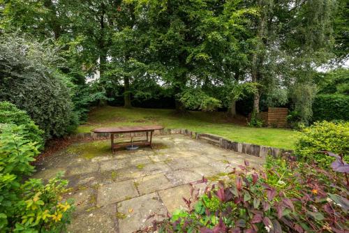 a picnic table in the middle of a garden at Middleton View in Ilkley