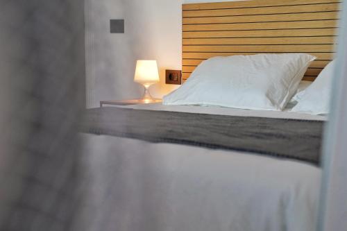 a bedroom with a bed with a lamp on it at Brisas al mar in Candelaria