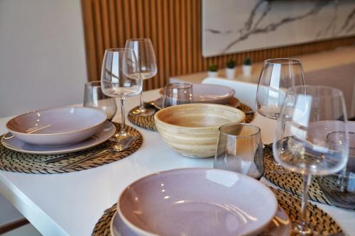 a table with glasses and plates and bowls on it at Brisas al mar in Candelaria
