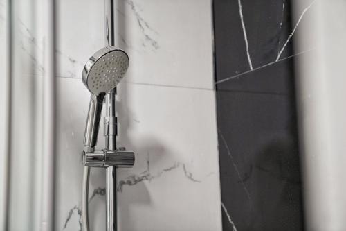 a shower head is attached to a wall at Brisas al mar in Candelaria