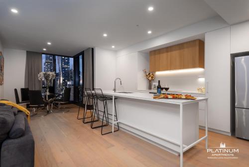 a kitchen with a counter and a living room at Platinum Luxury Stays at Aston in Melbourne