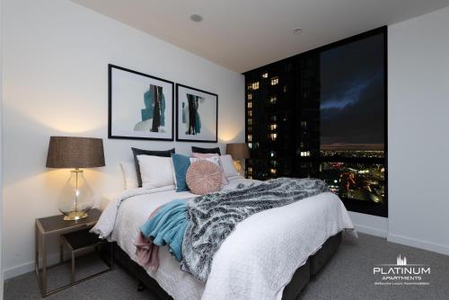 a bedroom with a bed and a large window at Platinum Luxury Stays at Aston in Melbourne