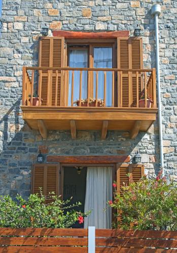 a wooden balcony on the side of a building at Kalo Nero Apartments in Makry Gialos