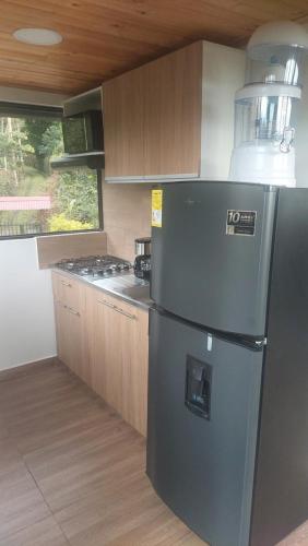 a kitchen with a refrigerator and a stove at Alojamiento natural rural LOS NOGALES in San Francisco