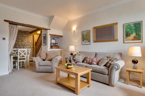 a living room with two couches and a table at Littlebeck in Kettlewell