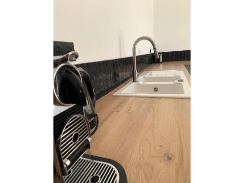 a kitchen with a sink and a chair next to it at Modern Villa with Pool in Brives in Brives-sur-Charente