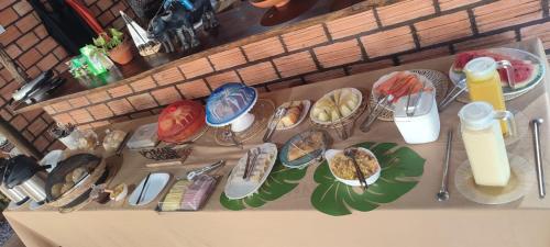 a bunch of plates of food on a table at POUSADA NOSSO CANTO ALTER in Alter do Chao