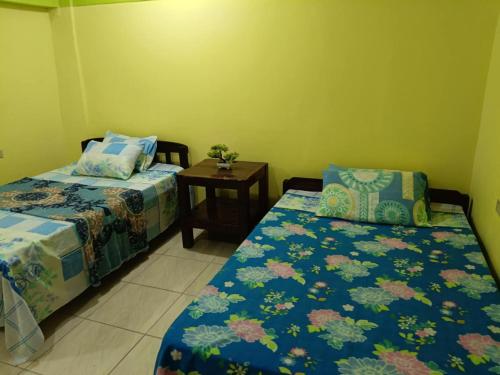 a room with two beds and a small table at Raya's Guesthouse Rainy Day Promo- No Downpayment Needed in Baguio
