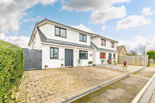 a white house with a driveway at Coastal Dreams in St Ives