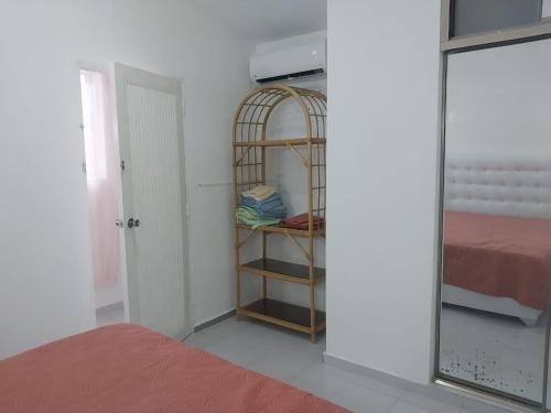 a room with a room with a bed and a mirror at Tropical Optimal Tropicana Sur in Sosúa