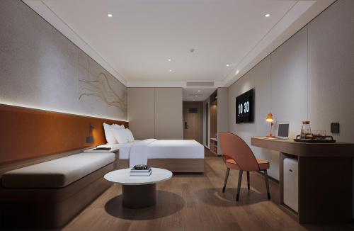 a hotel room with a bed and a table at Guangdong Baiyun City Hotel in Guangzhou
