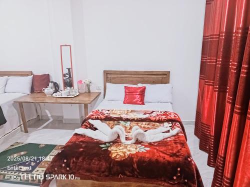 a bedroom with a bed with two people laying on it at Korean motel in Ohiya