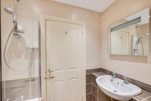 a bathroom with a sink and a shower and a mirror at Apple Barn in Fylingdales