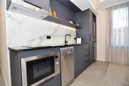 a kitchen with a sink and a stove top oven at Deco Hotel Canberra in Canberra