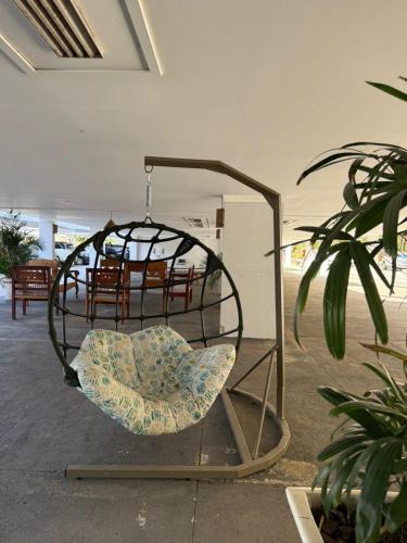 a chair in a bird cage in a room at Pontal do Lago Flat in Caldas Novas