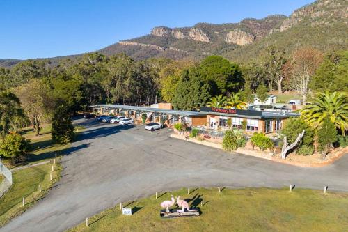 an aerial view of a resort with mountains in the background at The Grampians Motel in Halls Gap