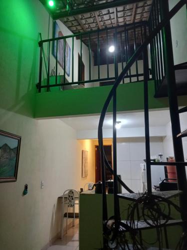 a staircase in a room with a green ceiling at Hostel Luz in Lençóis