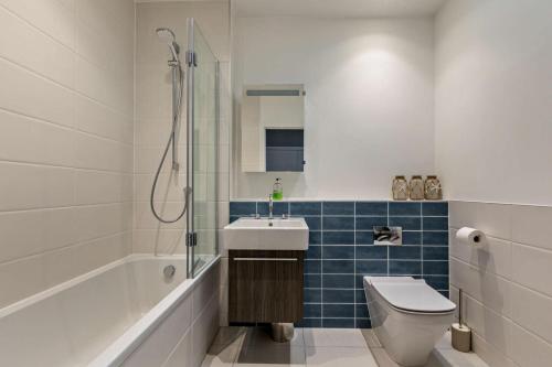 a bathroom with a toilet and a sink and a shower at Shore End - W1 in Woolacombe