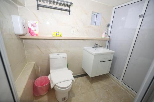 a small bathroom with a toilet and a shower at Sea Keelung in Keelung