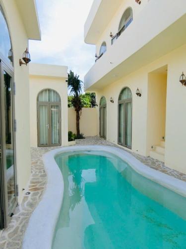 a swimming pool in front of a house at Le Cosmos 2 Vĩnh Hy in Vĩnh Hy