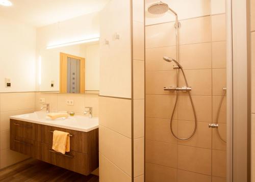 a bathroom with a shower and a sink at Hotel & Ferienappartements Edelweiss in Willingen