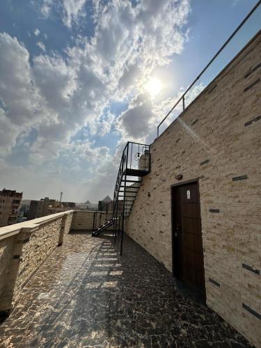 a brick building with a staircase on the side of it at king pyramids in Cairo