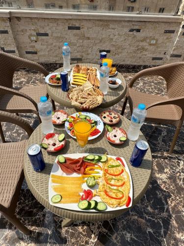 a table with plates of food and bottles of water at king pyramids in Cairo