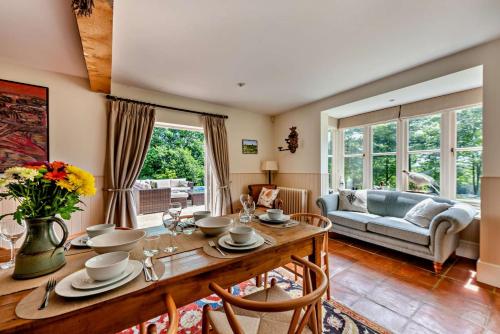 a living room with a table and a couch at Denswood House in Brightling